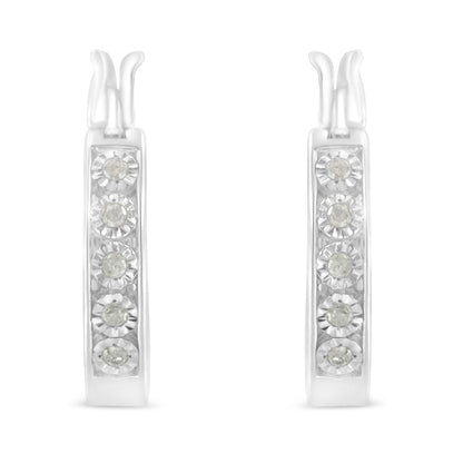 Front-facing view of white metal hoop earrings with round white gemstones in miracle setting.