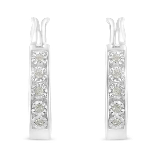 Front-facing view of white metal hoop earrings with round white gemstones in miracle setting.