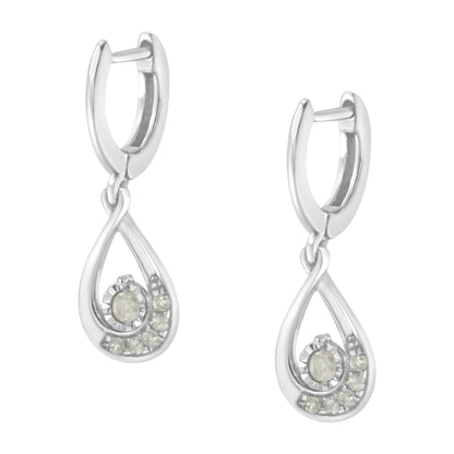 Front view of a pair of white metal drop earrings with a teardrop-shaped design featuring round white gemstones in a pave setting.