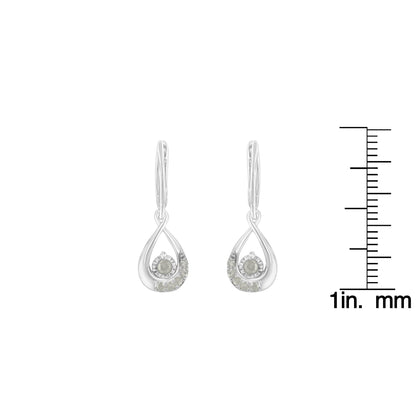 Pair of white metal drop earrings with round white gemstones in pave setting, front view on a ruler for size reference.