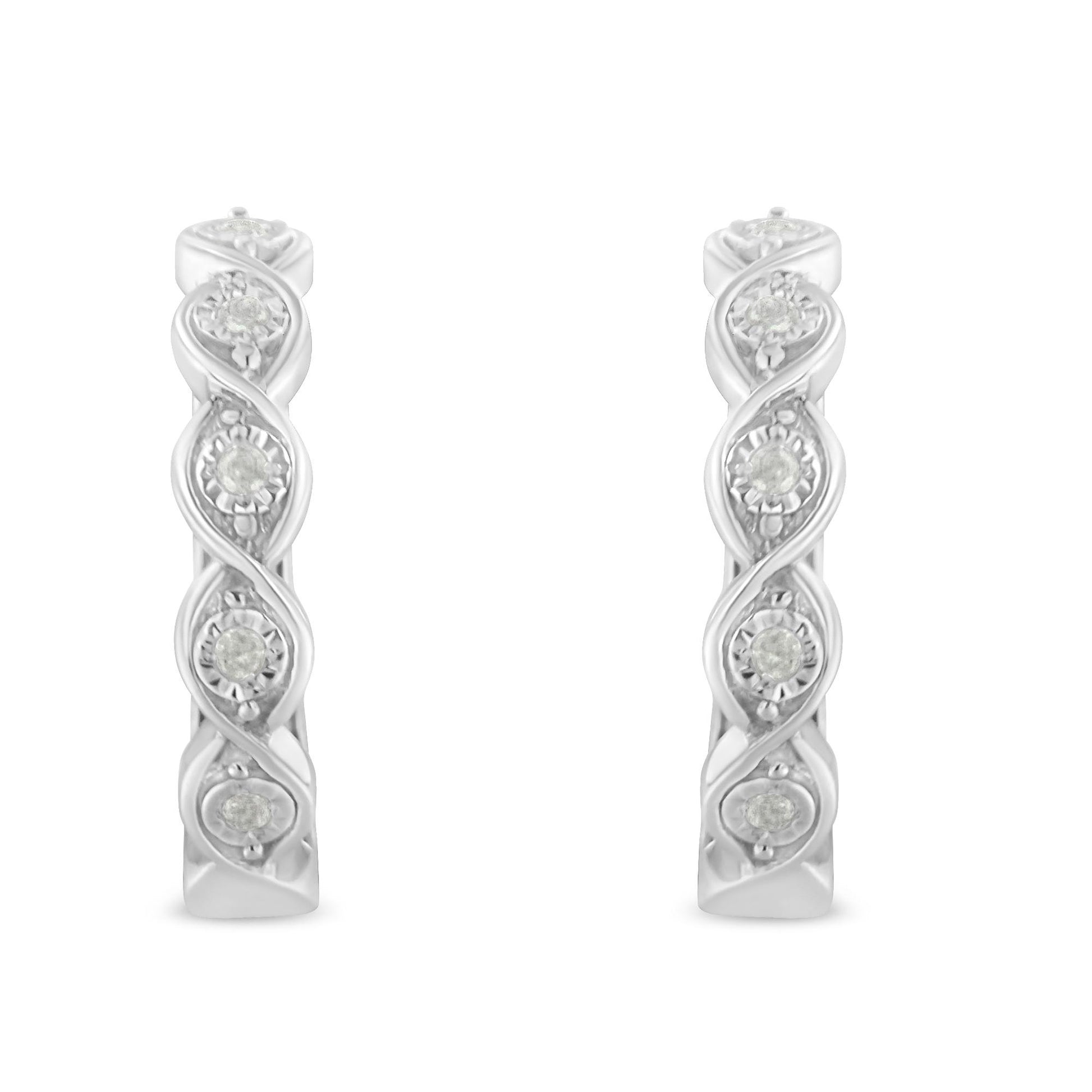 Front-facing shot of white metal hoop earrings featuring round white gemstones in a twisted design.