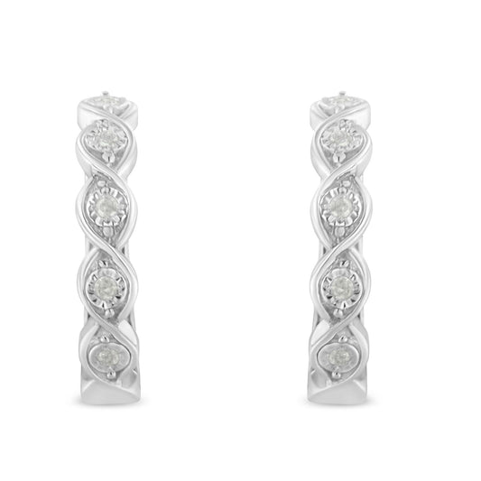 Front-facing shot of white metal hoop earrings featuring round white gemstones in a twisted design.