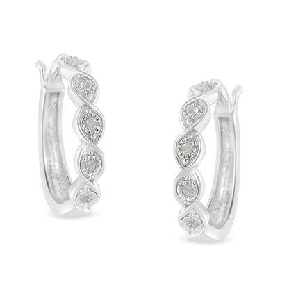 Pair of white metal hoop earrings with twisted design and round white gemstones set in a miracle setting, shown from a front angle.