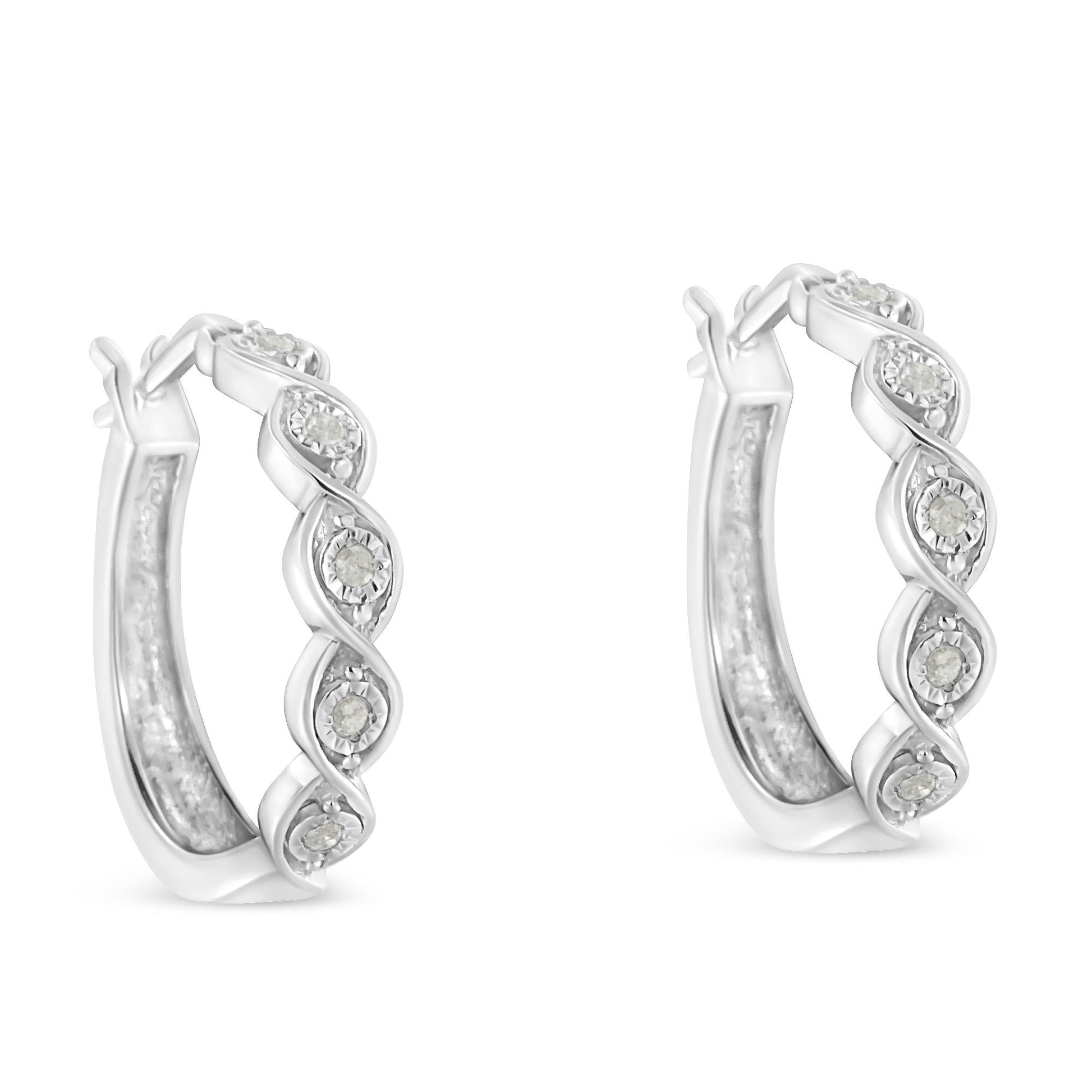 Pair of white metal hoop earrings with a twisted design featuring round white gemstones, front angle view.