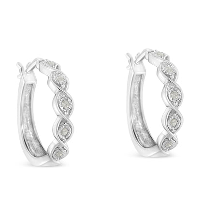 Pair of white metal hoop earrings with a twisted design featuring round white gemstones, front angle view.