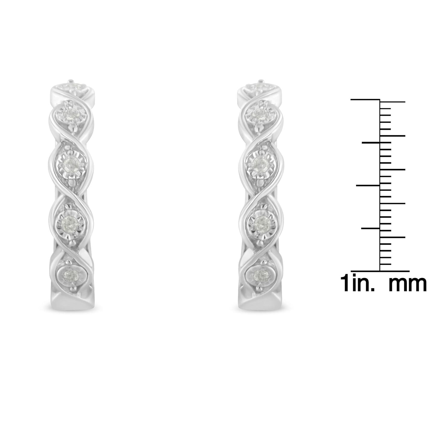 Front view of a pair of white metal earrings with a twisted design featuring round white gemstones in miracle settings, shown next to a ruler for size reference.