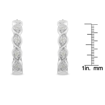 Front view of a pair of white metal earrings with a twisted design featuring round white gemstones in miracle settings, shown next to a ruler for size reference.