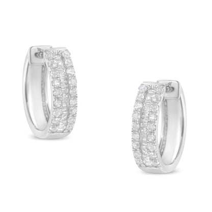 Front angle view of a pair of white metal hoop earrings featuring two rows of round white gemstones in a pave setting flanking a central row of baguette white gemstones in a channel setting.