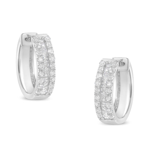 Front angle view of a pair of white metal hoop earrings featuring two rows of round white gemstones in a pave setting flanking a central row of baguette white gemstones in a channel setting.