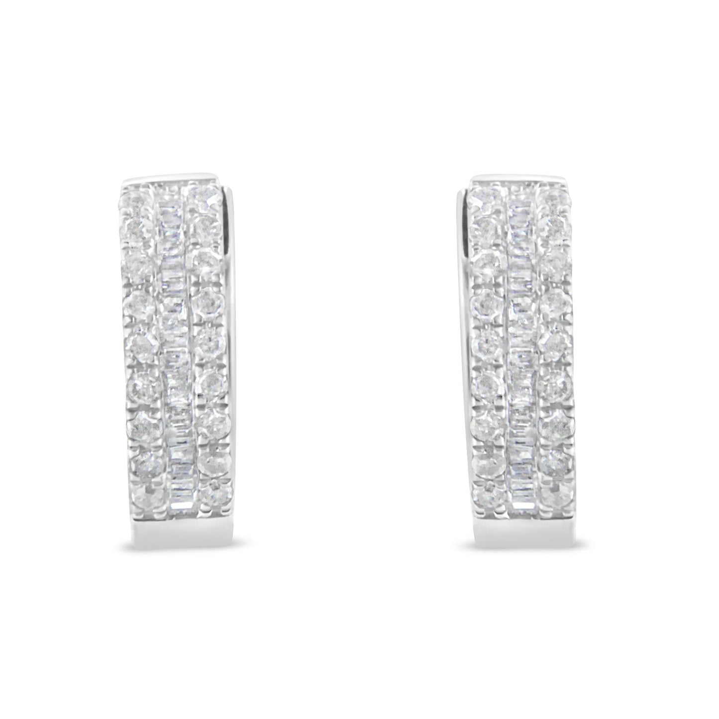 Front-facing pair of white metal earrings with rows of round white gemstones in pavé setting flanking a central row of baguette-shaped white gemstones in channel setting.