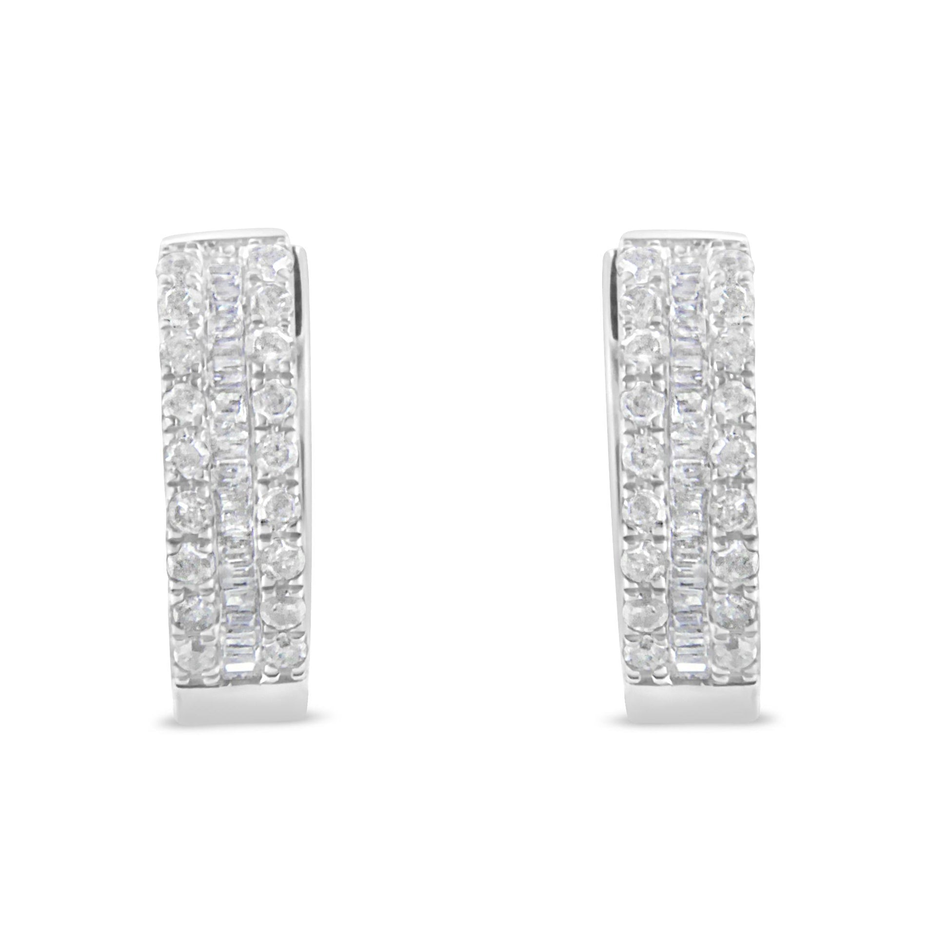 Front-facing pair of white metal earrings with rows of round white gemstones in pavé setting flanking a central row of baguette-shaped white gemstones in channel setting.