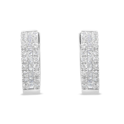 Front-facing pair of white metal earrings with rows of round white gemstones in pavé setting flanking a central row of baguette-shaped white gemstones in channel setting.