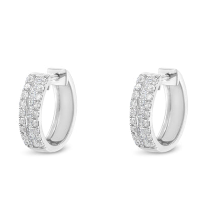 Front angled view of a pair of white hoop earrings featuring two rows of pave set round white gemstones on the outer edge and a center row of channel set baguette white gemstones.
