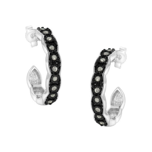 Pair of two-toned hoop earrings with a twisted design, featuring a row of white round gemstones in miracle settings along the front, shown at a slight angle on a white background.