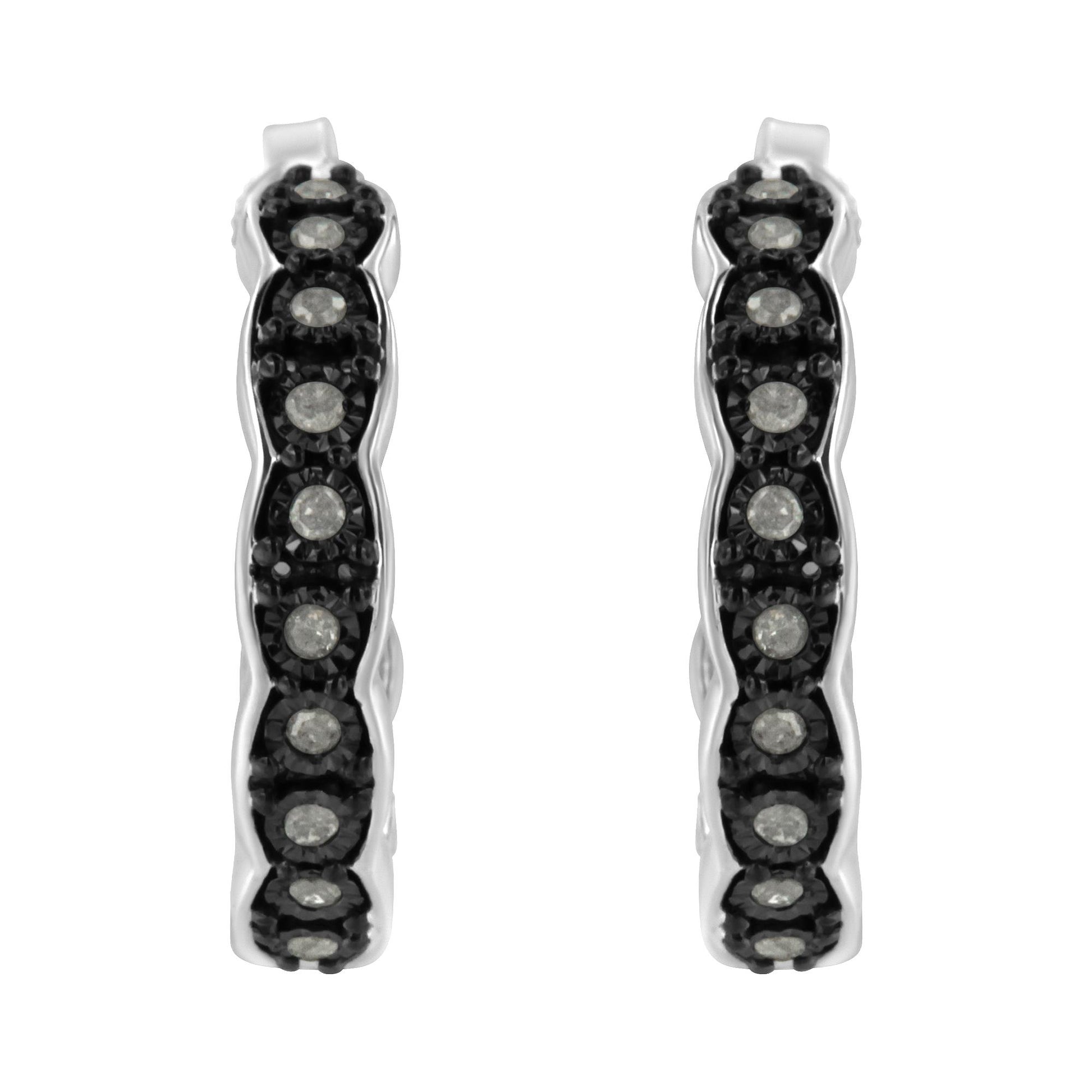 Front-facing close-up of two-toned hoop earrings set with round white gemstones in a miracle setting.