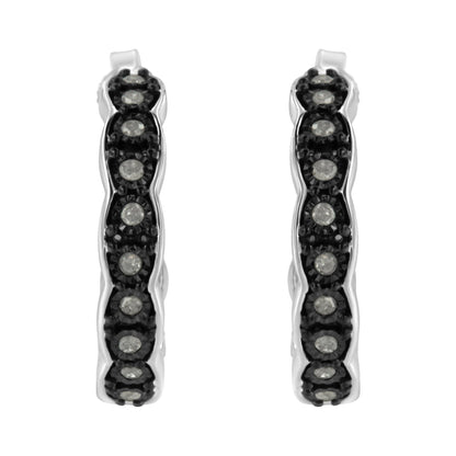 Front-facing close-up of two-toned hoop earrings set with round white gemstones in a miracle setting.