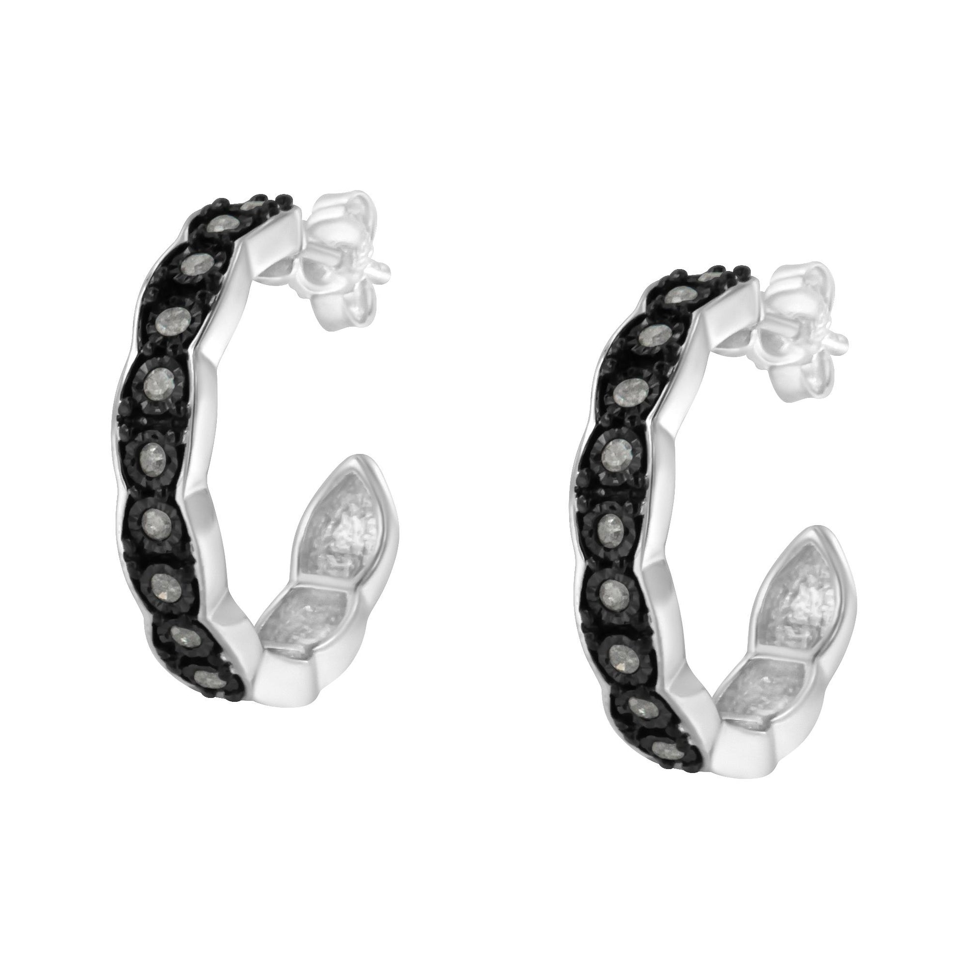 Pair of two-toned hoop earrings with round white gemstones in a miracle setting, shown at a slight angle.