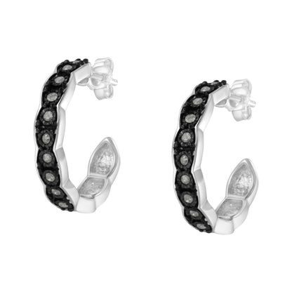 Pair of two-toned hoop earrings with round white gemstones in a miracle setting, shown at a slight angle.