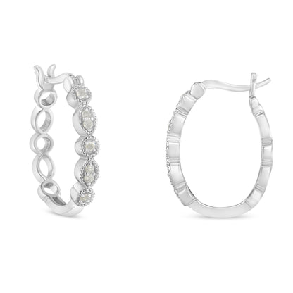 Pair of white metal hoop earrings with round white gemstones in prong settings, shown from front and side angles.
