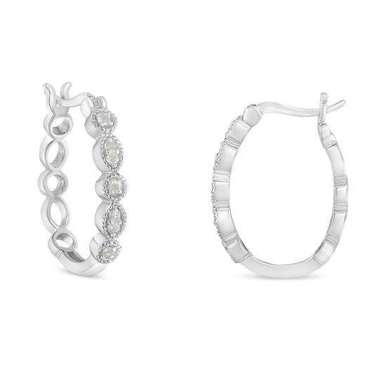 Pair of white metal hoop earrings with round white gemstones in prong settings, shown from front and side angles.