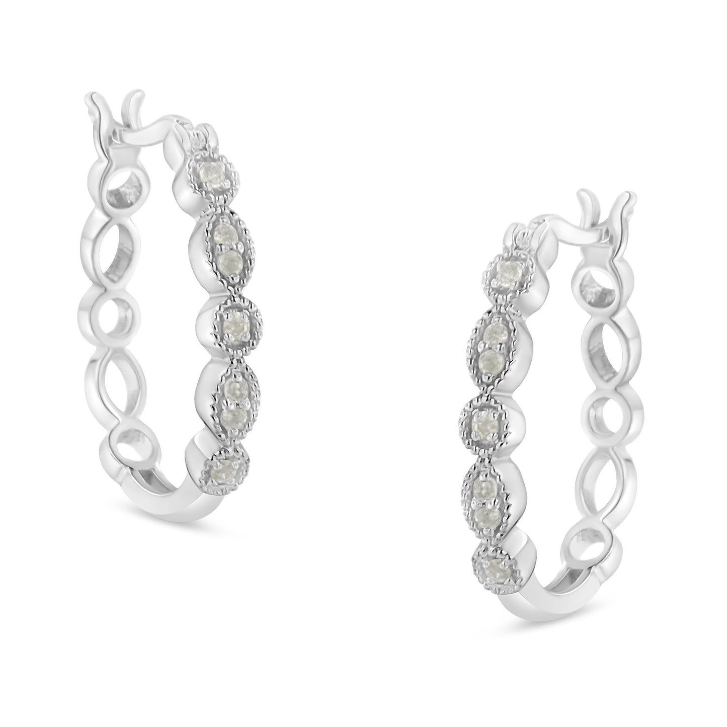 Pair of white metal hoop earrings with round white gemstones in prong settings, shown at an angled front view.