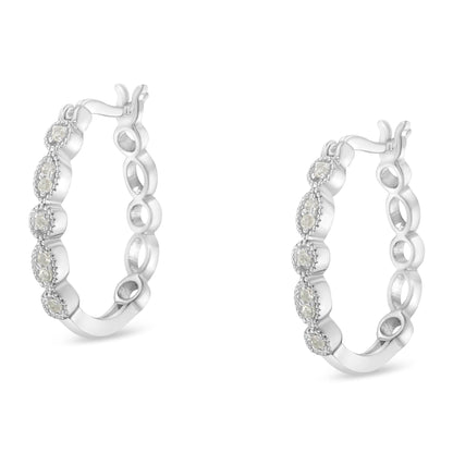 Pair of white metal hoop earrings with round white gemstones set in prong settings, shown from a front angle on a white background.