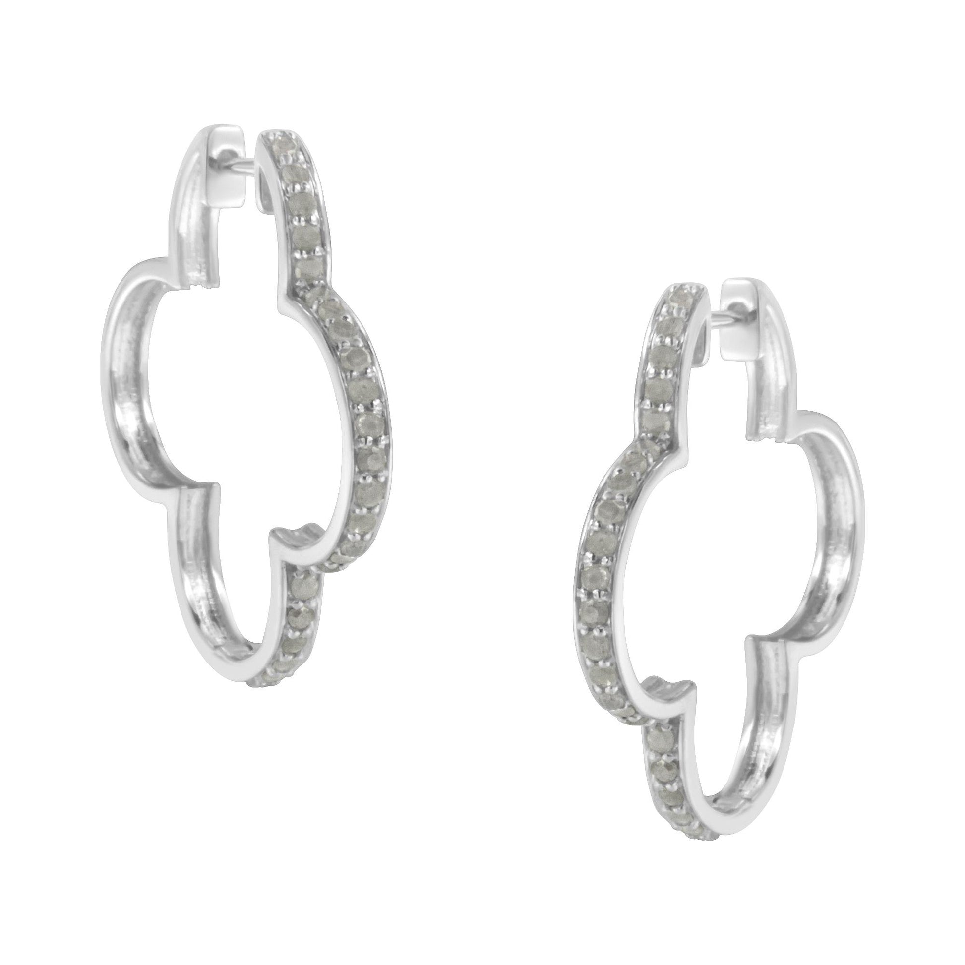 Pair of white metal earrings with a rounded quatrefoil shape, adorned with prong-set white round gemstones, shown from a front angle.