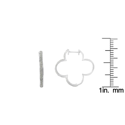 White metal earrings with a floral-inspired open shape, set with round white gemstones in prong settings, shown from side and front angles, displayed next to a ruler for size reference.