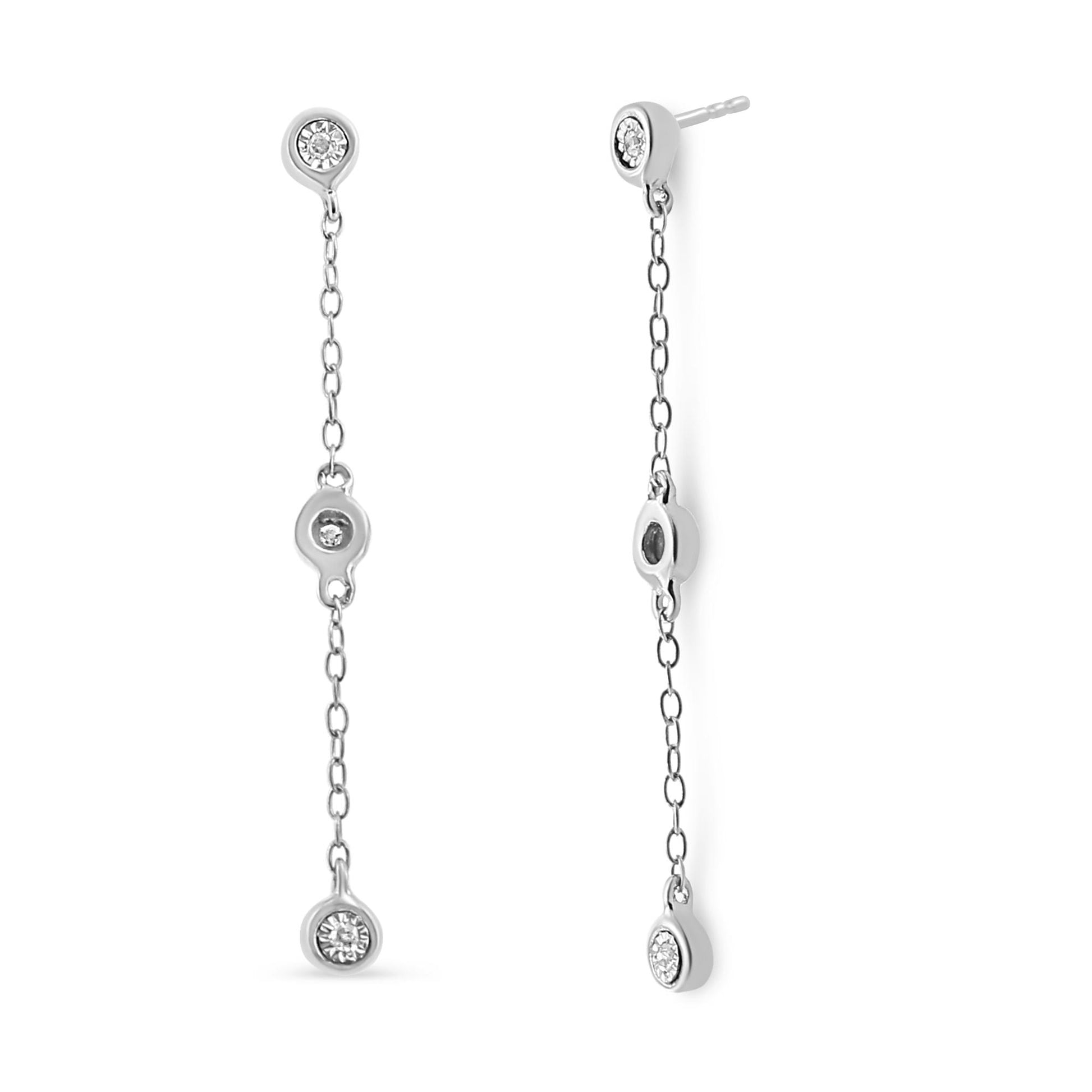 Front and side view of long white metal chain drop earrings each featuring three white round gemstones in a miracle setting.