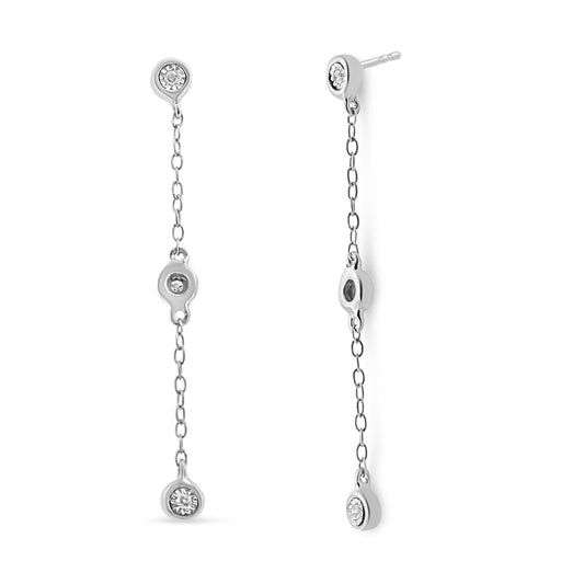 Front and side view of long white metal chain drop earrings each featuring three white round gemstones in a miracle setting.