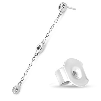 White metal dangle earring with round white gemstones in miracle setting, shown at an angled top-down view with earring back beside it.