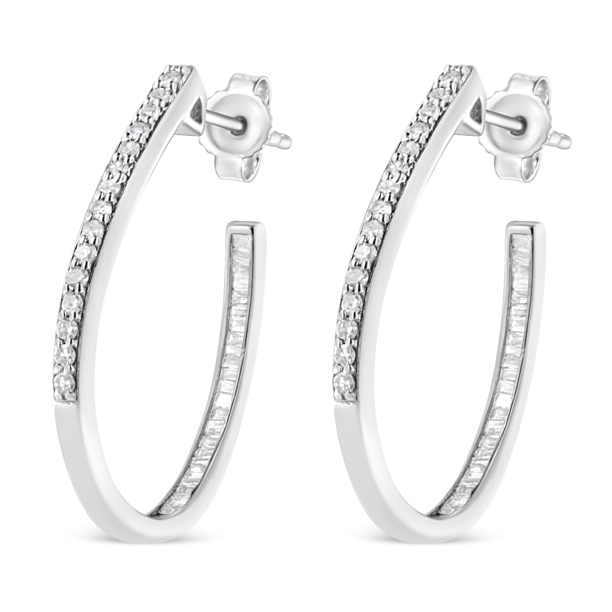 Pair of white metal hoop earrings with round prong-set white gemstones on the front outer edge and baguette channel-set white gemstones on the inner edge, shown from a front angled view.