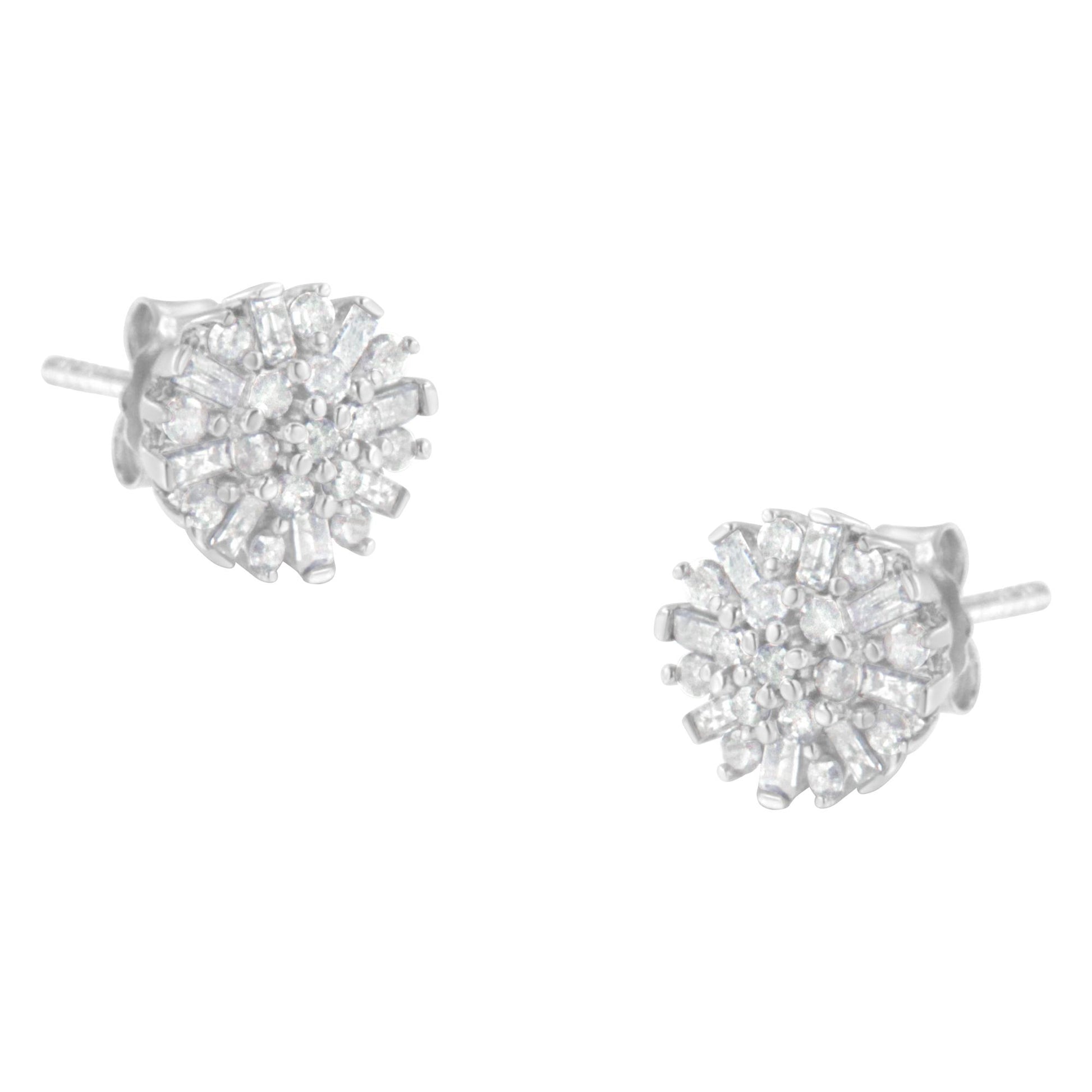 Pair of white metal stud earrings with round and baguette white gemstones, viewed from a slight side angle.