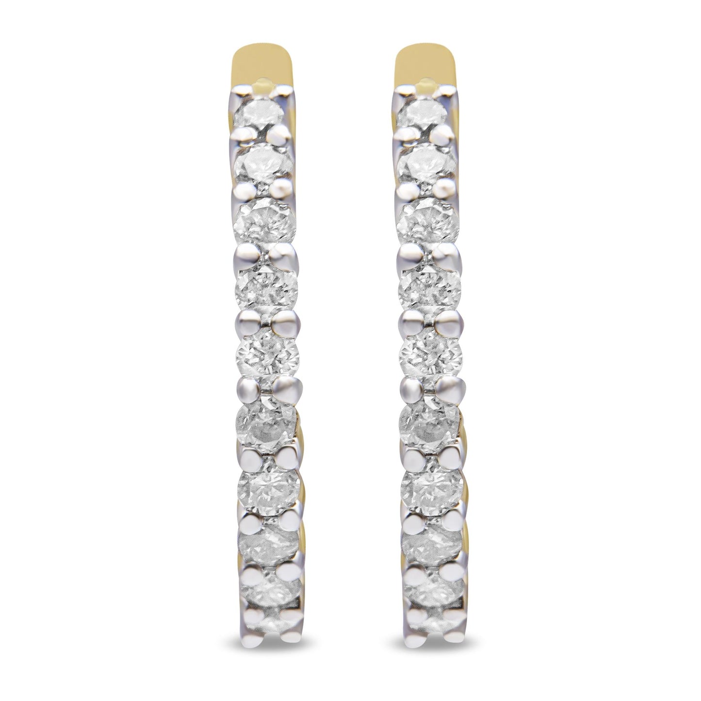 Front facing close-up of pair of yellow metal hoop earrings set with round white gemstones in prong settings.