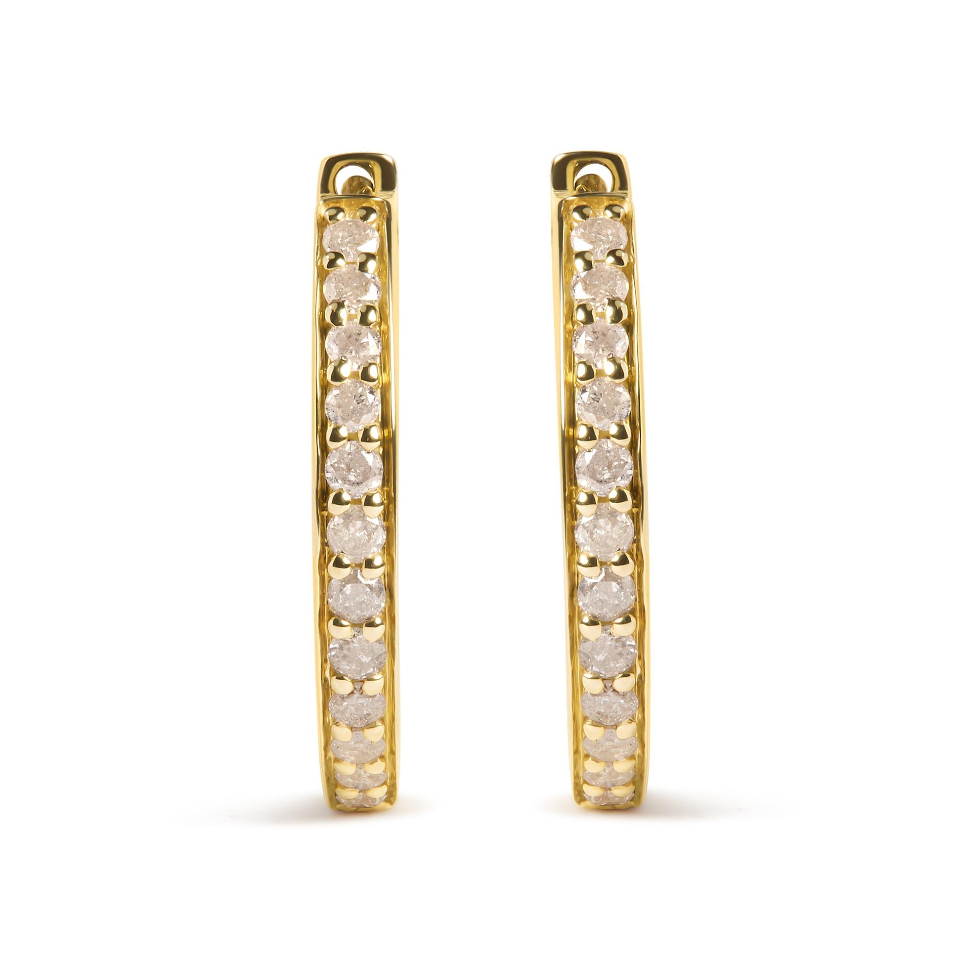 Front-facing view of a pair of yellow metal hoop earrings with prong-set round white gemstones along the outer edge.