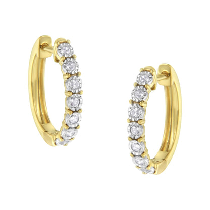 Close-up image of two-toned hoop earrings set with round white gemstones in a continuous row, shown from a slightly angled front view.
