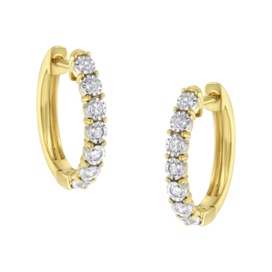 Close-up image of two-toned hoop earrings set with round white gemstones in a continuous row, shown from a slightly angled front view.