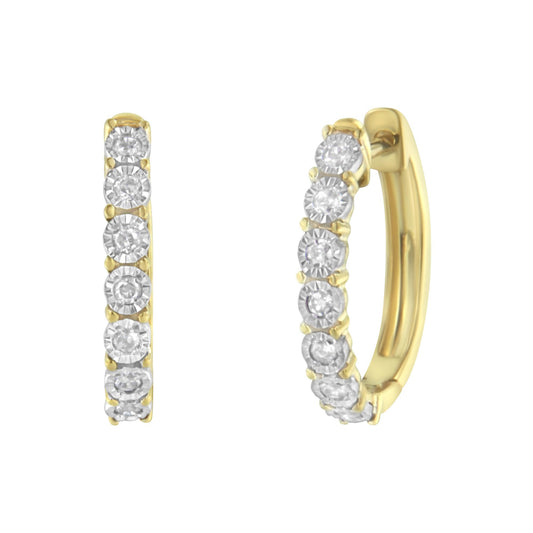 Two-toned hoop earrings with round white gemstones in a miracle setting, shown from a side and front angle.