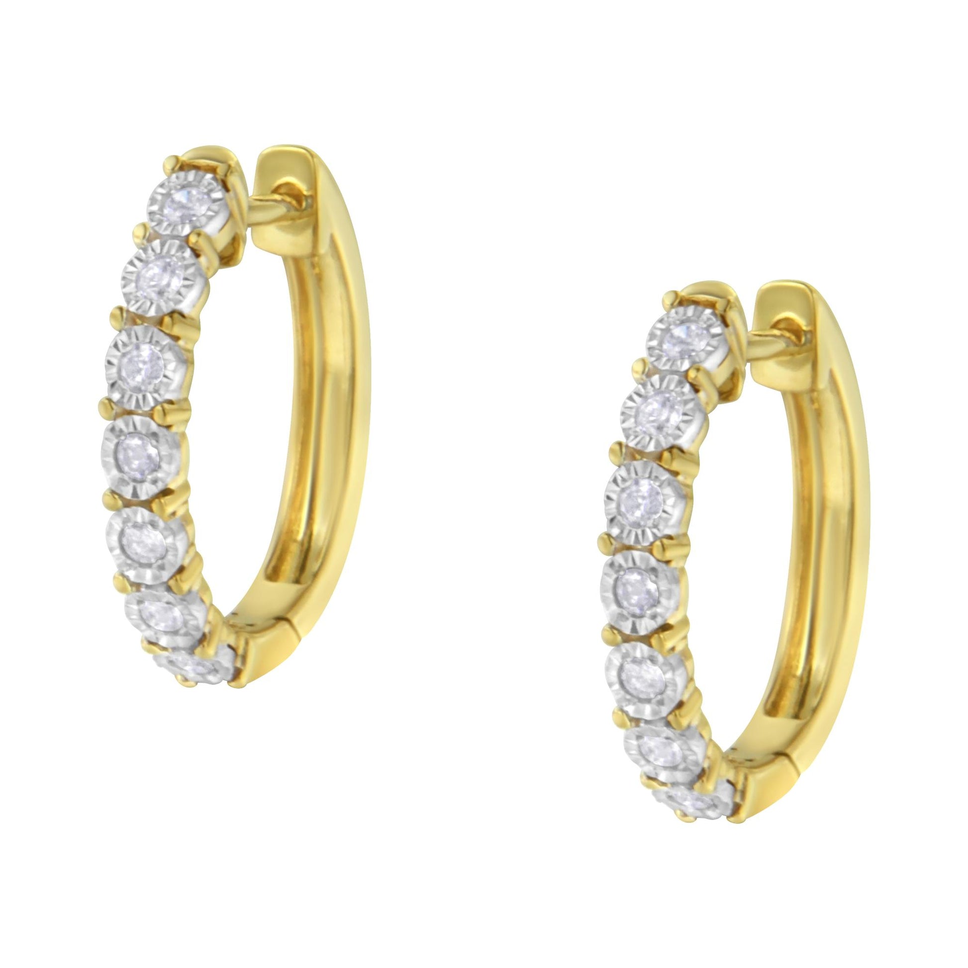 Close-up angled view of two-toned hoop earrings with round white gemstones set along the front in a miracle setting.