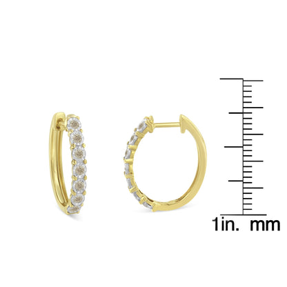 Two-toned hoop earrings with round white gemstones set along the front, shown from front and side angles, next to a ruler for size reference.