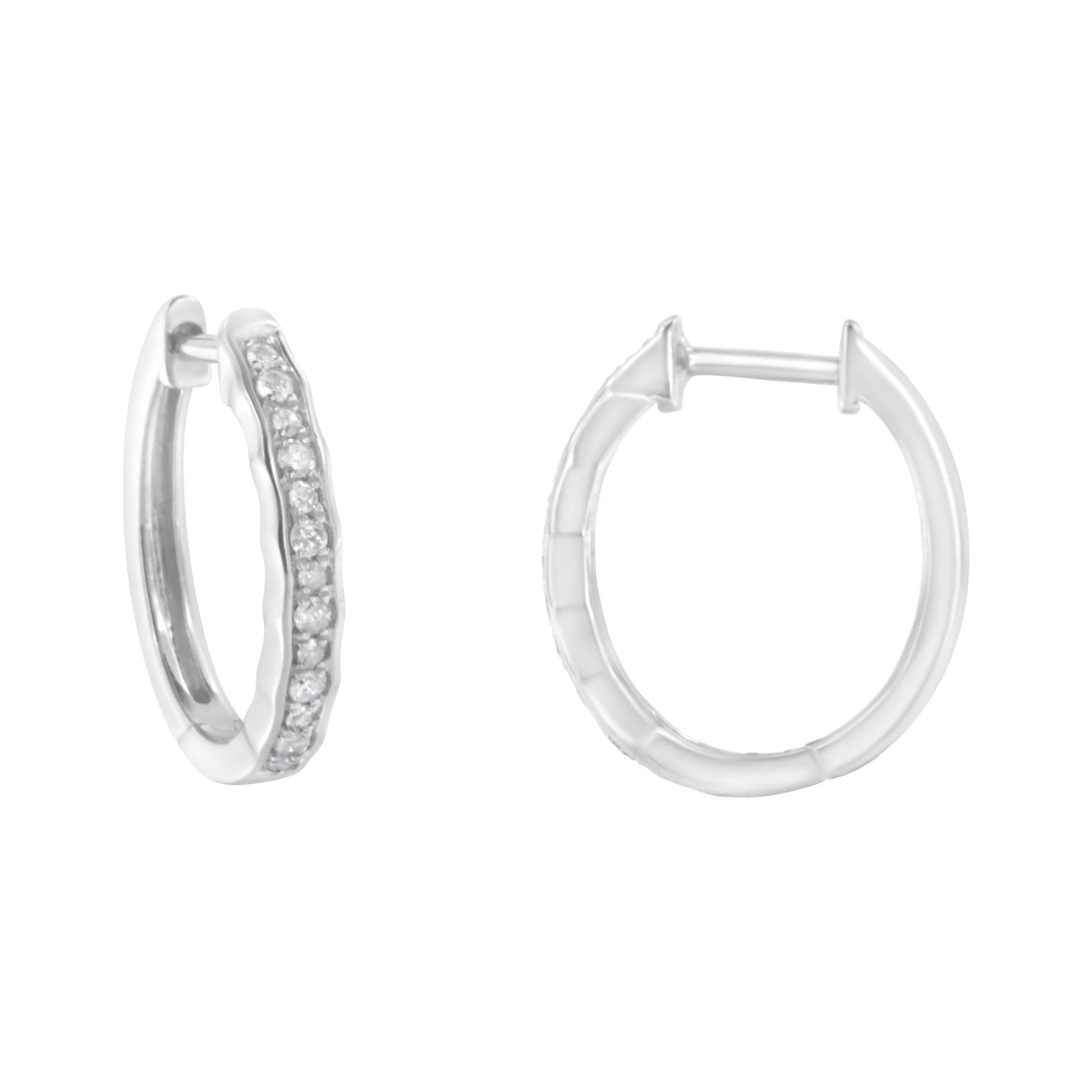 Pair of white metal hoop earrings, one shown from front angled view displaying pave set round white gemstones, the other from back, on white background.