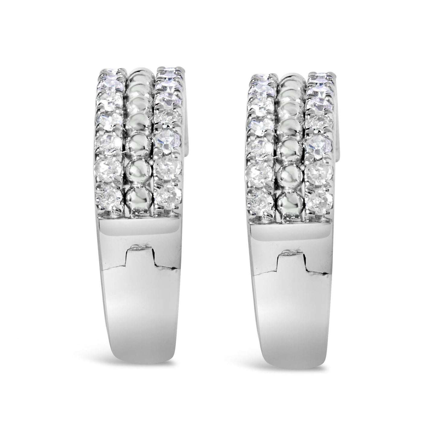 Front view of a pair of white metal hoop earrings with three rows of round white gemstones in a pave setting along the front.