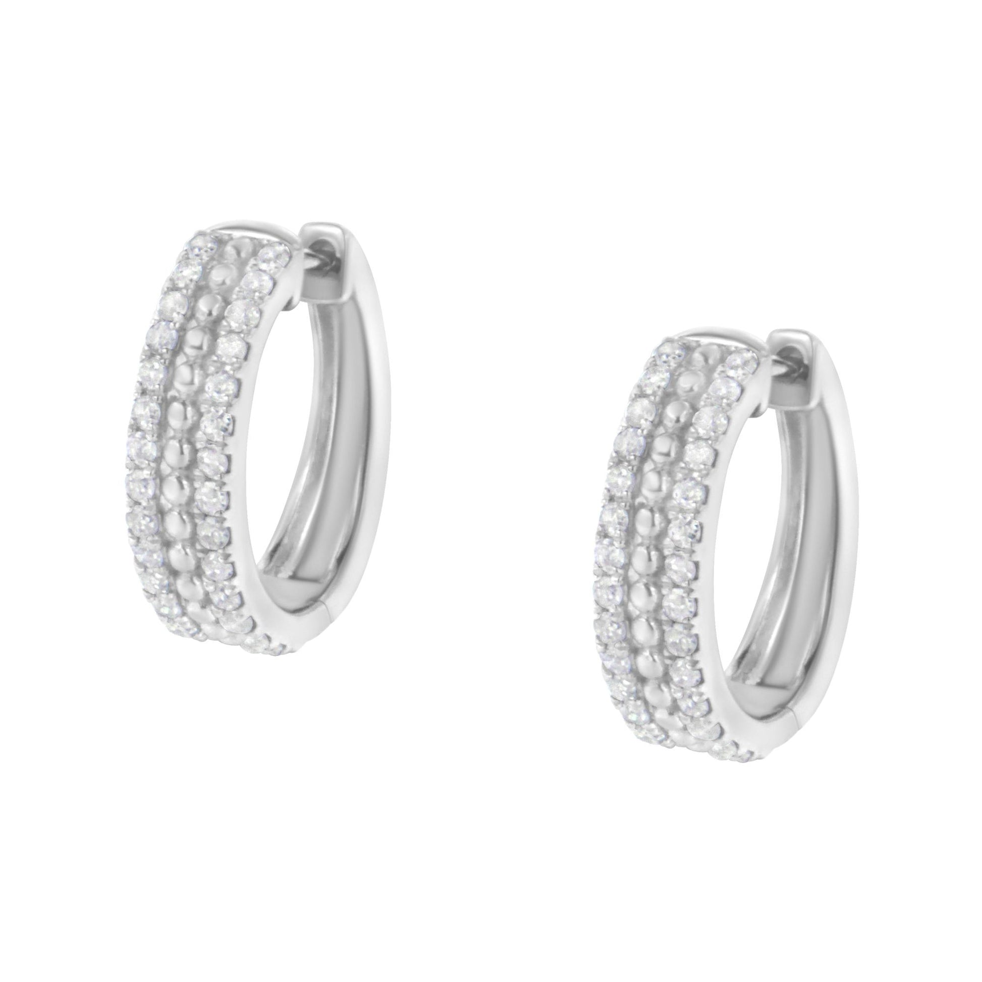 Pair of white metal hoop earrings with multiple rows of pave-set round white gemstones, shown from a front angle.