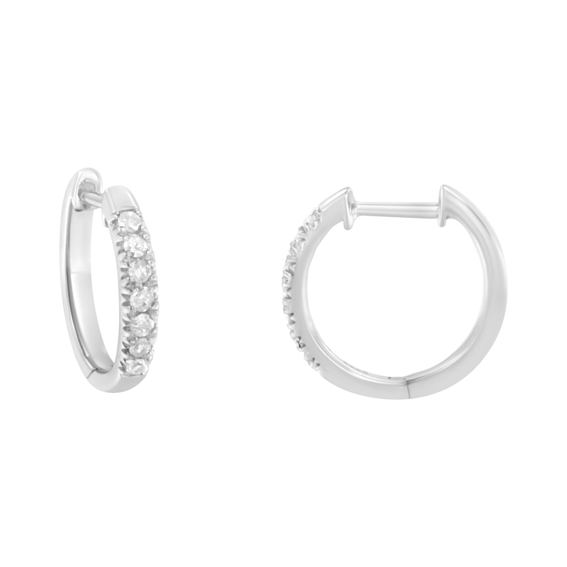 Front and side angled view of a pair of white metal hoop earrings with round white gemstones in prong settings along the front half of each hoop.
