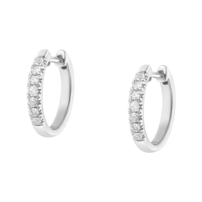 Pair of white hoop earrings with round white gemstones in prong setting visible on the front, shown against a white background from a slight angle.