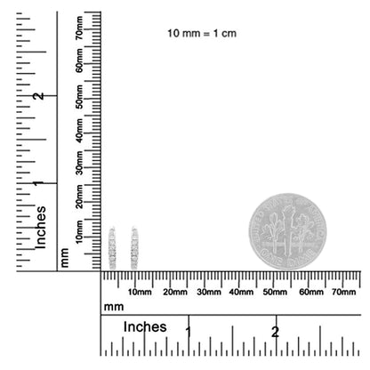Pair of white metal white gemstone round prong set earrings shown on a ruler and scale for size reference, front angle.