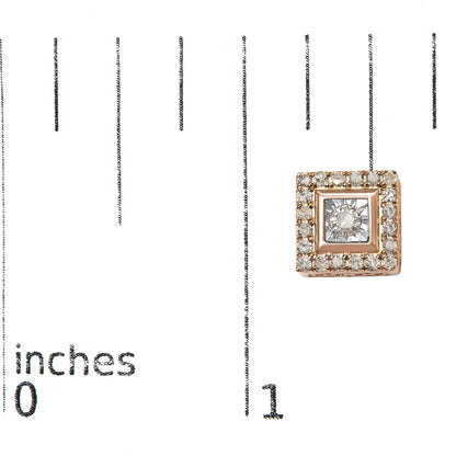 Close-up front view of a square rose metal earring with a central white gemstone in a miracle setting surrounded by smaller white gemstones in a prong setting, shown on a ruler for size reference.