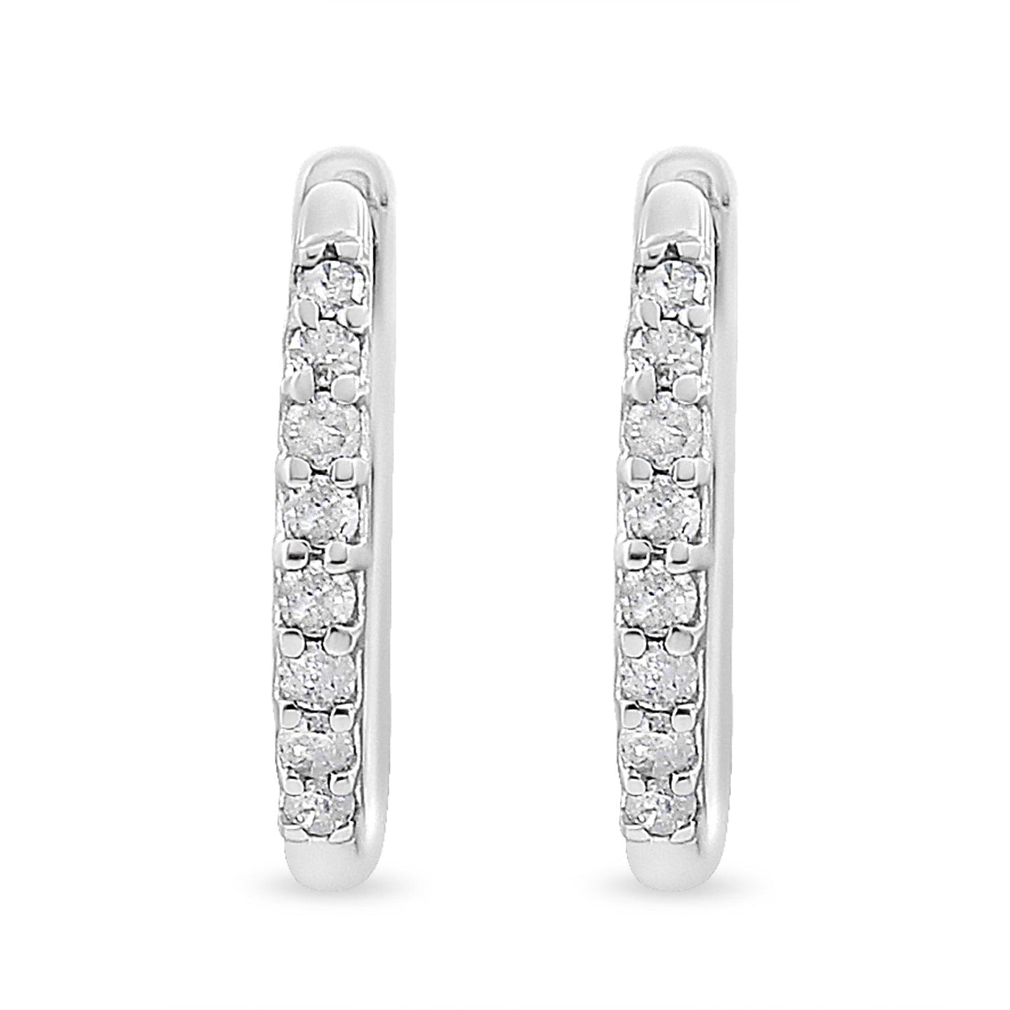 Front-facing close-up of white metal earrings set with round white gemstones in prong settings.