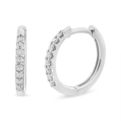 Close-up front and side view of white hoop earrings with round white gemstones in prong settings along the front outer edge.
