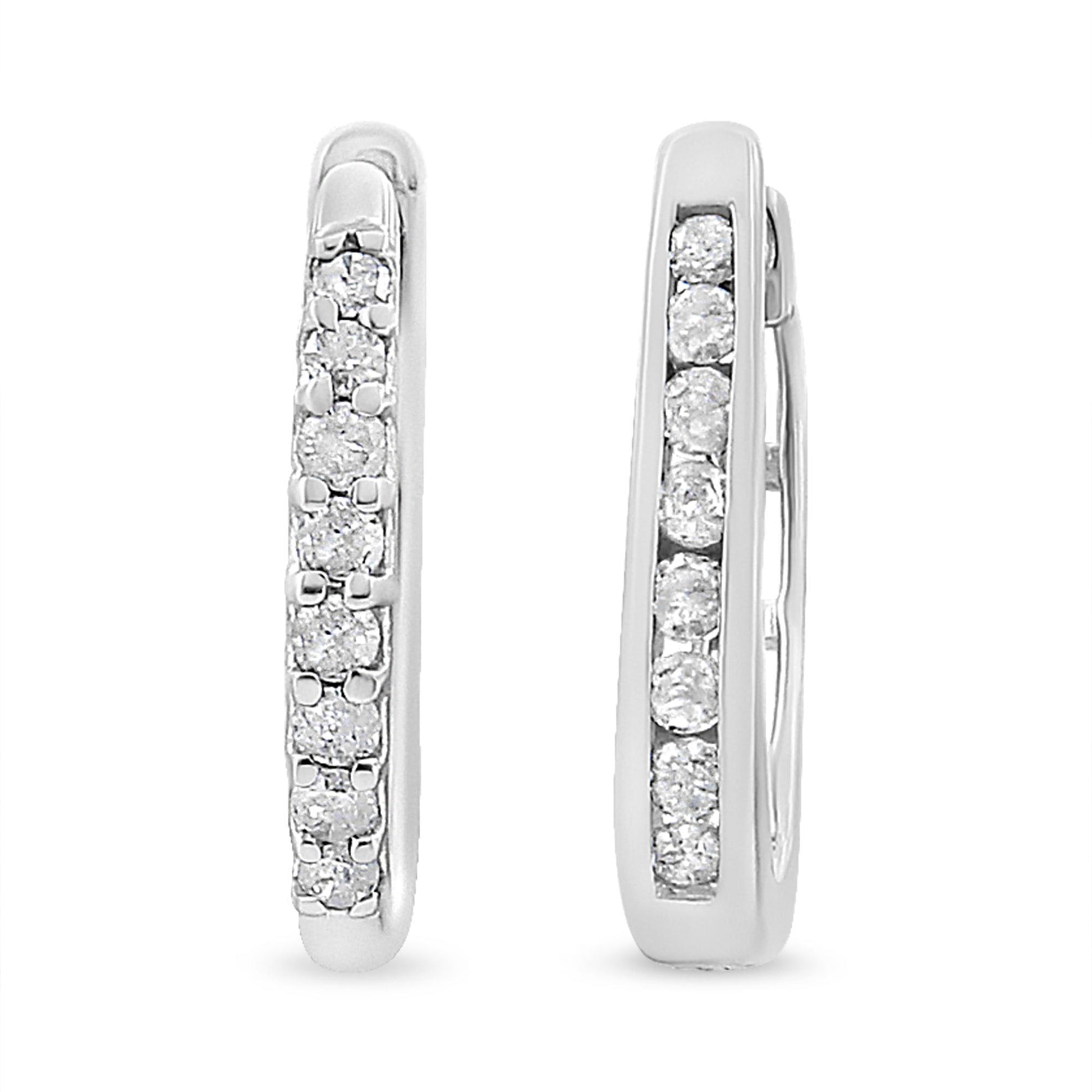 Front and side view of white metal hoop earrings with round white gemstones in prong settings along the front.